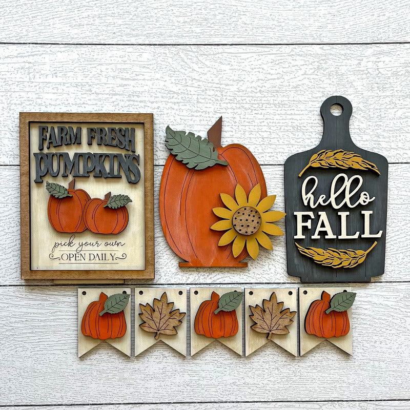 Set of autumn-themed decorative signs on a wooden surface