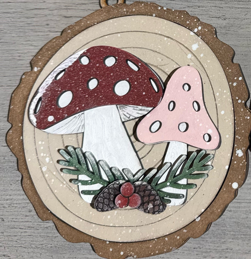 mushrooms and foliage on a wooden ornament