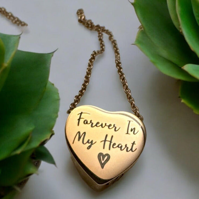 Gold heart-shaped pendant with 'Forever In My Heart' engraving on a chain laser engraved in Boise Idaho