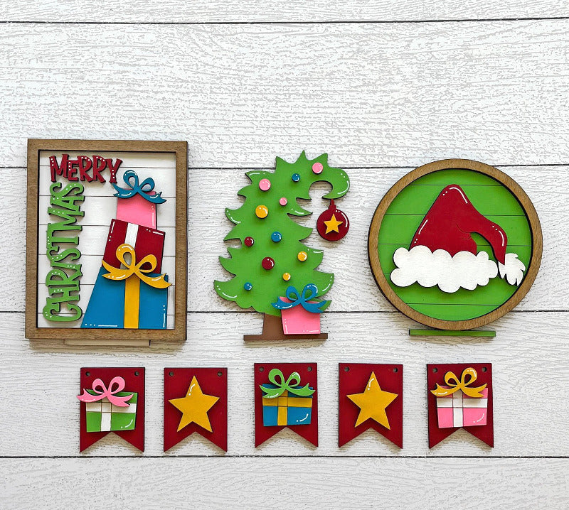 Set of colorful Christmas-themed decorative items on a wooden surface.